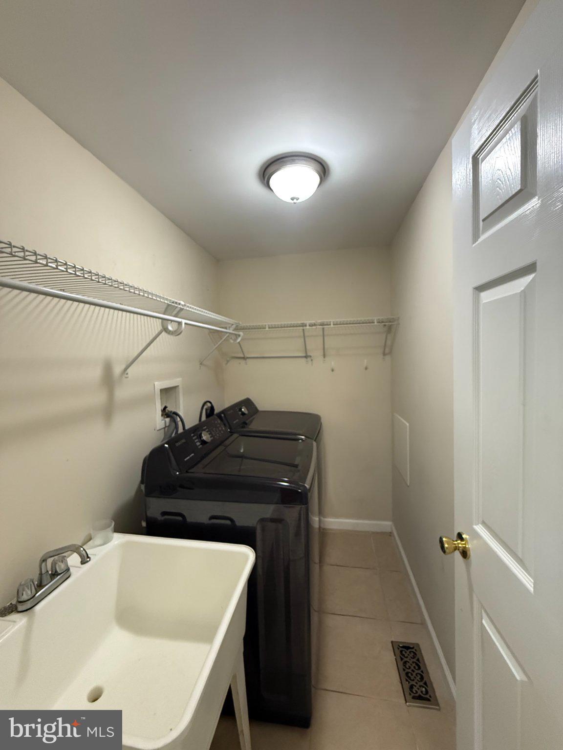 123 Winters Lane Baltimore, MD 21228 - Photo 9 of 28 Modern laundry space with ample storage.