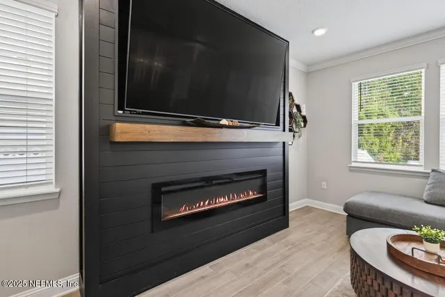 a kitchen that has a lot of cabinets in it and wooden floors