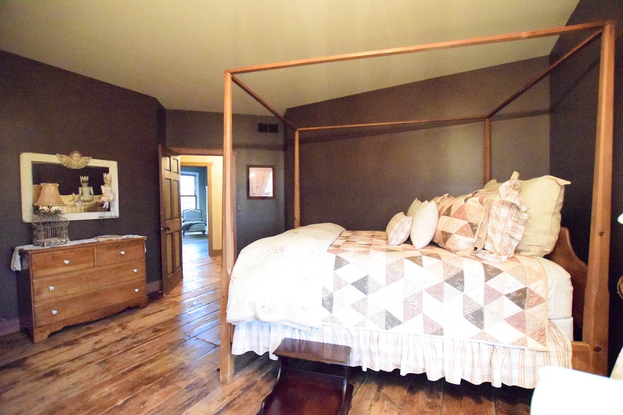 929 East State Line Road Orangeville, IL 61060 - Photo 16 of 25 a bedroom with a bed and dresser with wooden floor