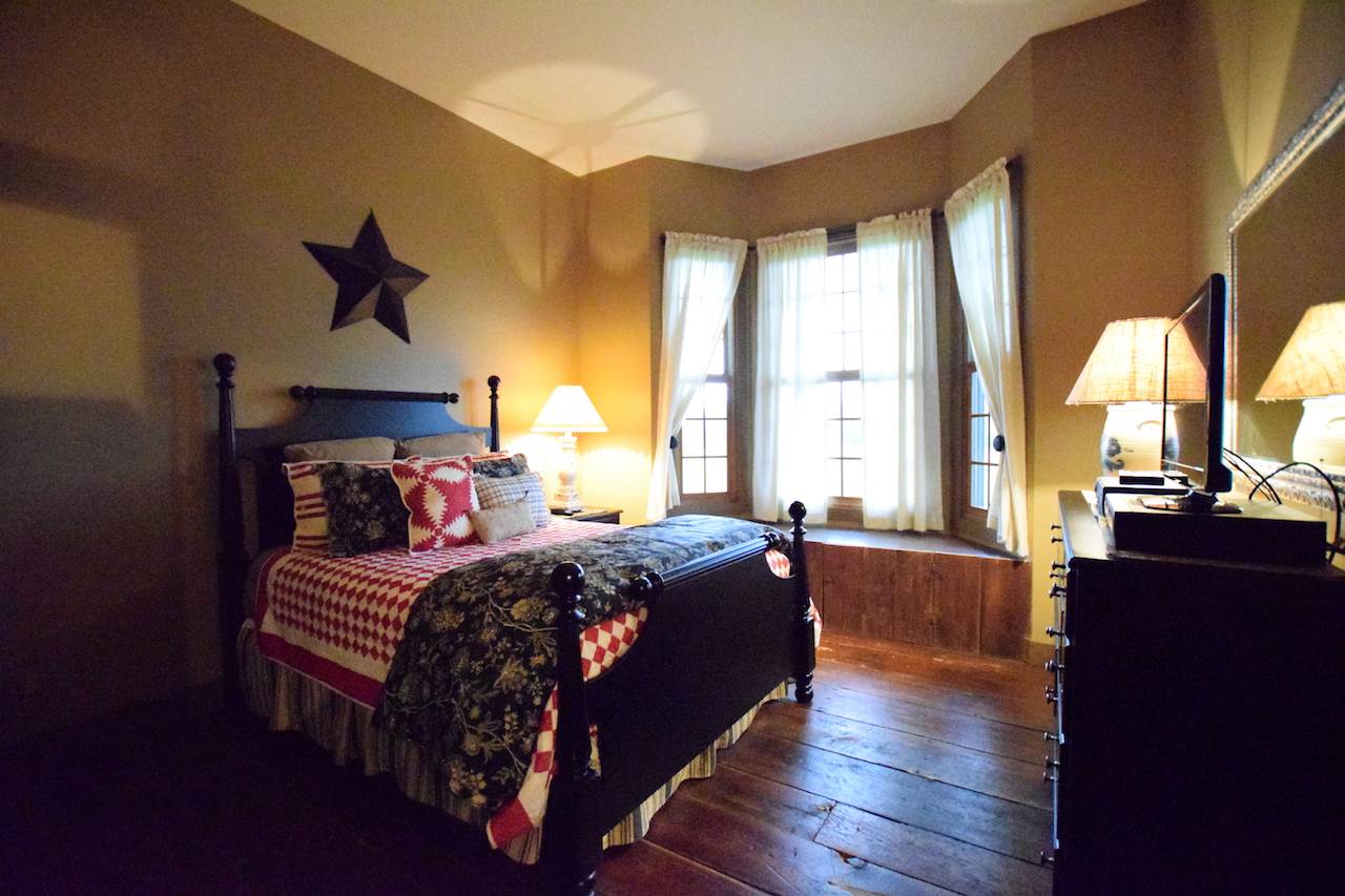 929 East State Line Road Orangeville, IL 61060 - Photo 18 of 25 a bed room with a bed and a large window
