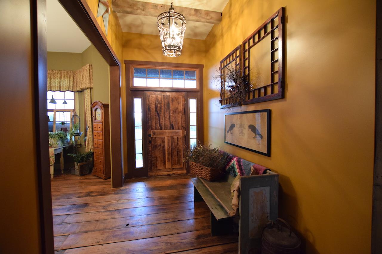 929 East State Line Road Orangeville, IL 61060 - Photo 2 of 25 a view of a hallway with wooden floor and staircase
