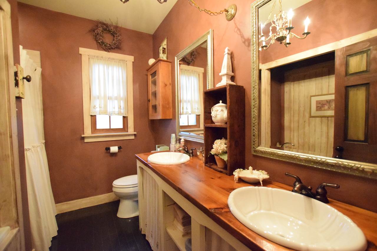 929 East State Line Road Orangeville, IL 61060 - Photo 21 of 25 a bathroom with a granite countertop double vanity sink a mirror and a toilet