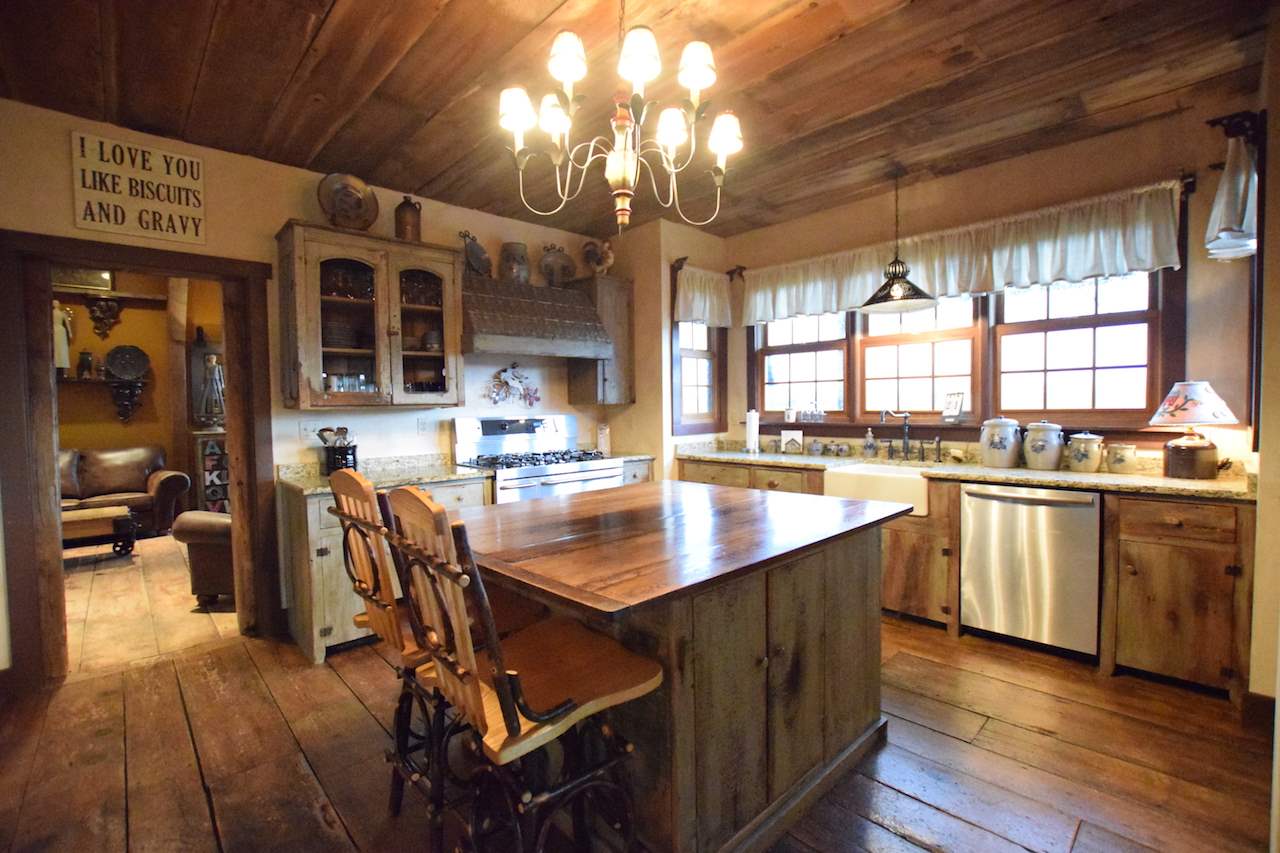 929 East State Line Road Orangeville, IL 61060 - Photo 5 of 25 a kitchen with stainless steel appliances granite countertop a stove top oven a sink dishwasher and white cabinets with wooden floor
