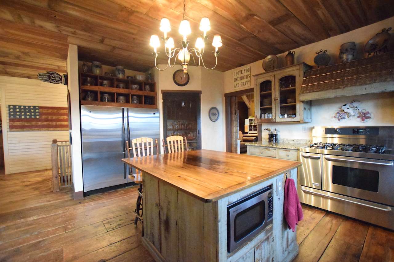929 East State Line Road Orangeville, IL 61060 - Photo 7 of 25 a kitchen with stainless steel appliances granite countertop a stove a sink and a refrigerator