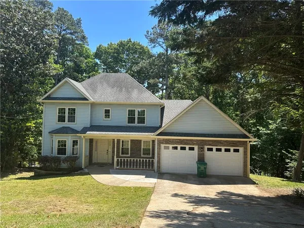 a front view of a house with a yard