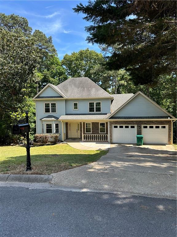 3305 Maple Ridge Court Suwanee, GA 30024 - Photo 2 of 33 a front view of a house with a garden