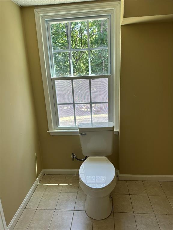 3305 Maple Ridge Court Suwanee, GA 30024 - Photo 25 of 33 a bathroom with a toilet a sink and a window