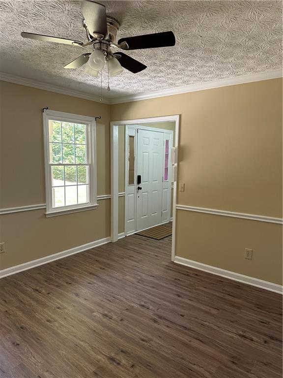 3305 Maple Ridge Court Suwanee, GA 30024 - Photo 3 of 33 an empty room with wooden floor chandelier fan and windows