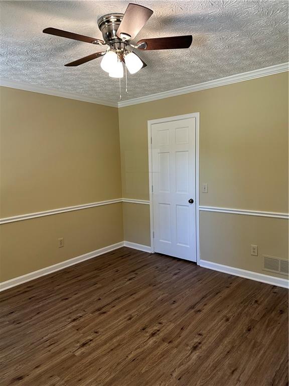 3305 Maple Ridge Court Suwanee, GA 30024 - Photo 5 of 33 an empty room with wooden floor fan and windows