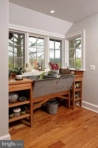 a bathroom with a granite countertop sink and a bathtub