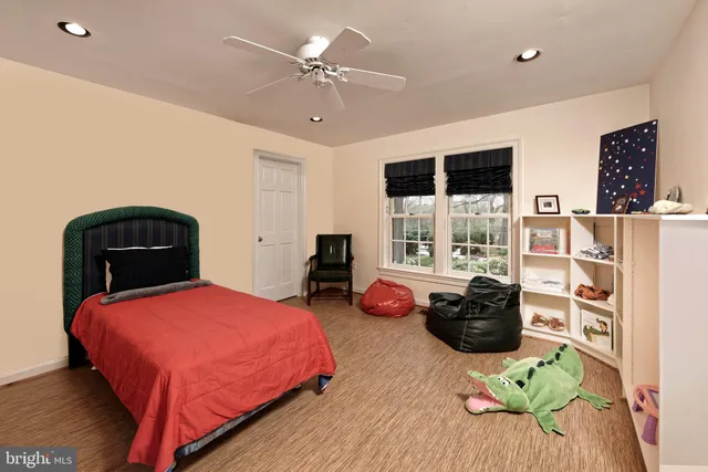 a bed room with two beds and large windows