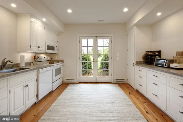 a house with lots of trees in the background