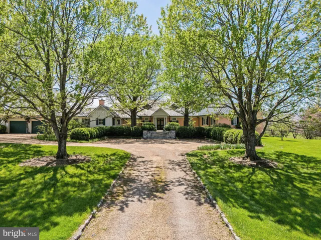 a dining room with furniture and a window