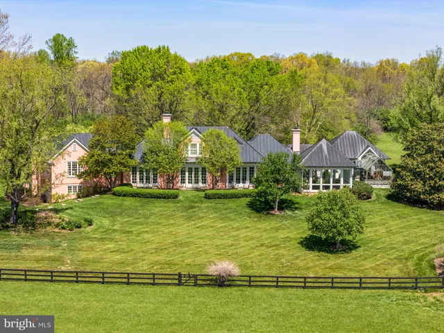 a view of a balcony with table and chairs and wooden fence