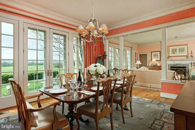 a kitchen with stainless steel appliances granite countertop a sink a stove a refrigerator cabinets and a dining table