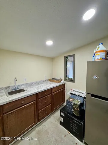 a spacious bathroom with a sink and a mirror
