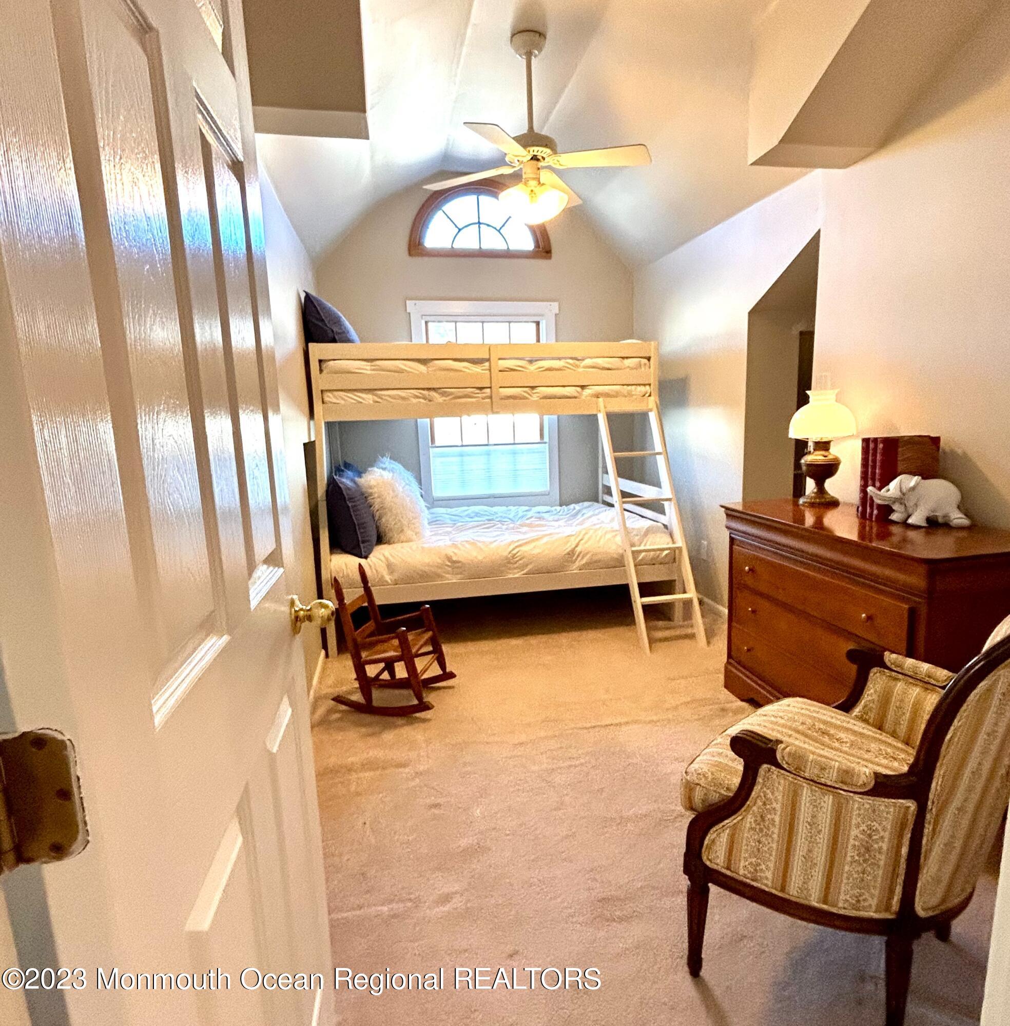 208 Passaic Avenue Spring Lake, NJ 07762 - Photo 12 of 19 a bedroom with furniture and a chandelier