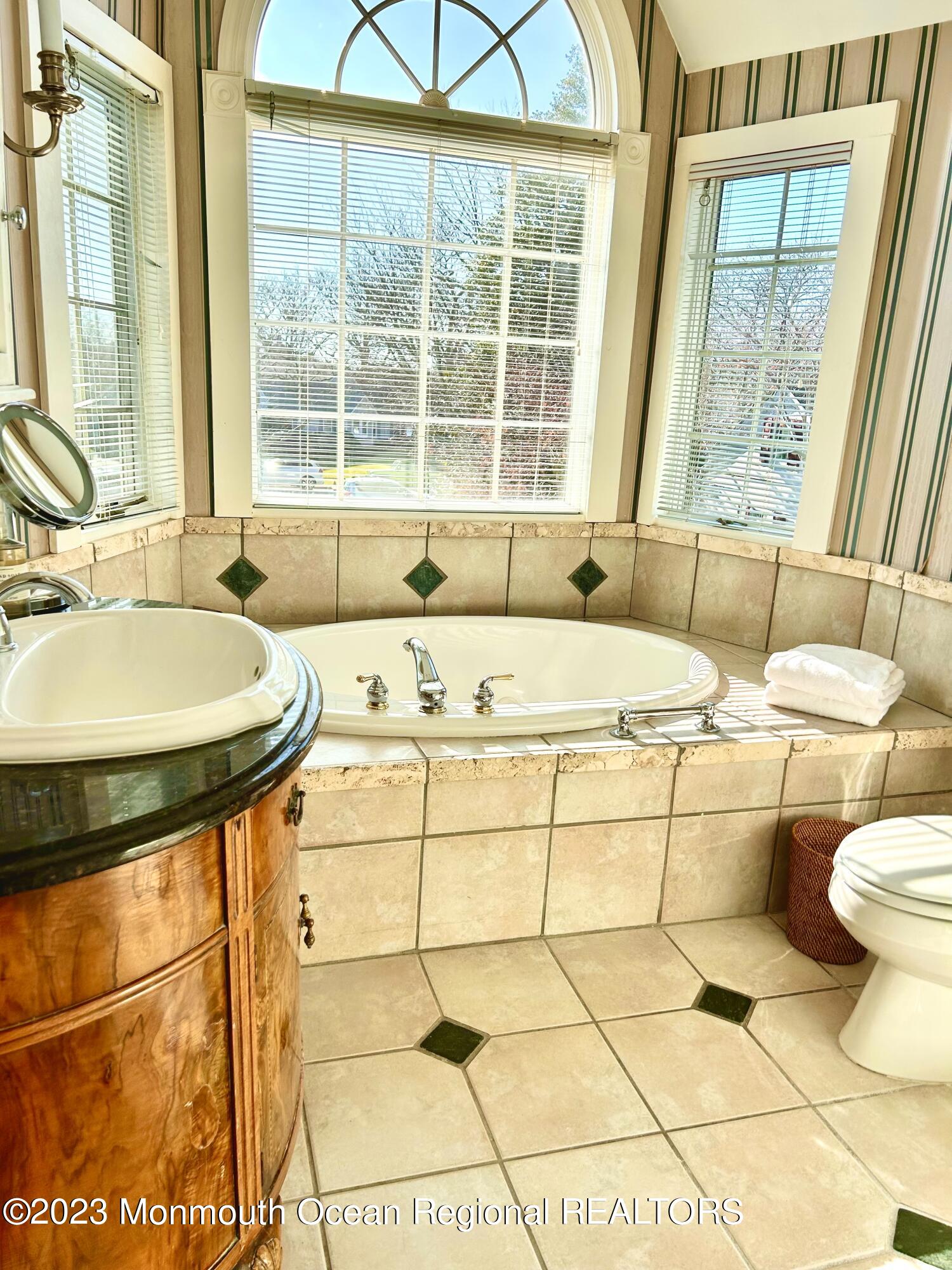 208 Passaic Avenue Spring Lake, NJ 07762 - Photo 14 of 19 a bathroom with a sink a bathtub and next to a window