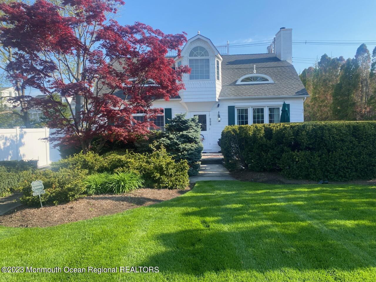 208 Passaic Avenue Spring Lake, NJ 07762 - Photo 2 of 19 a front view of a house with a garden