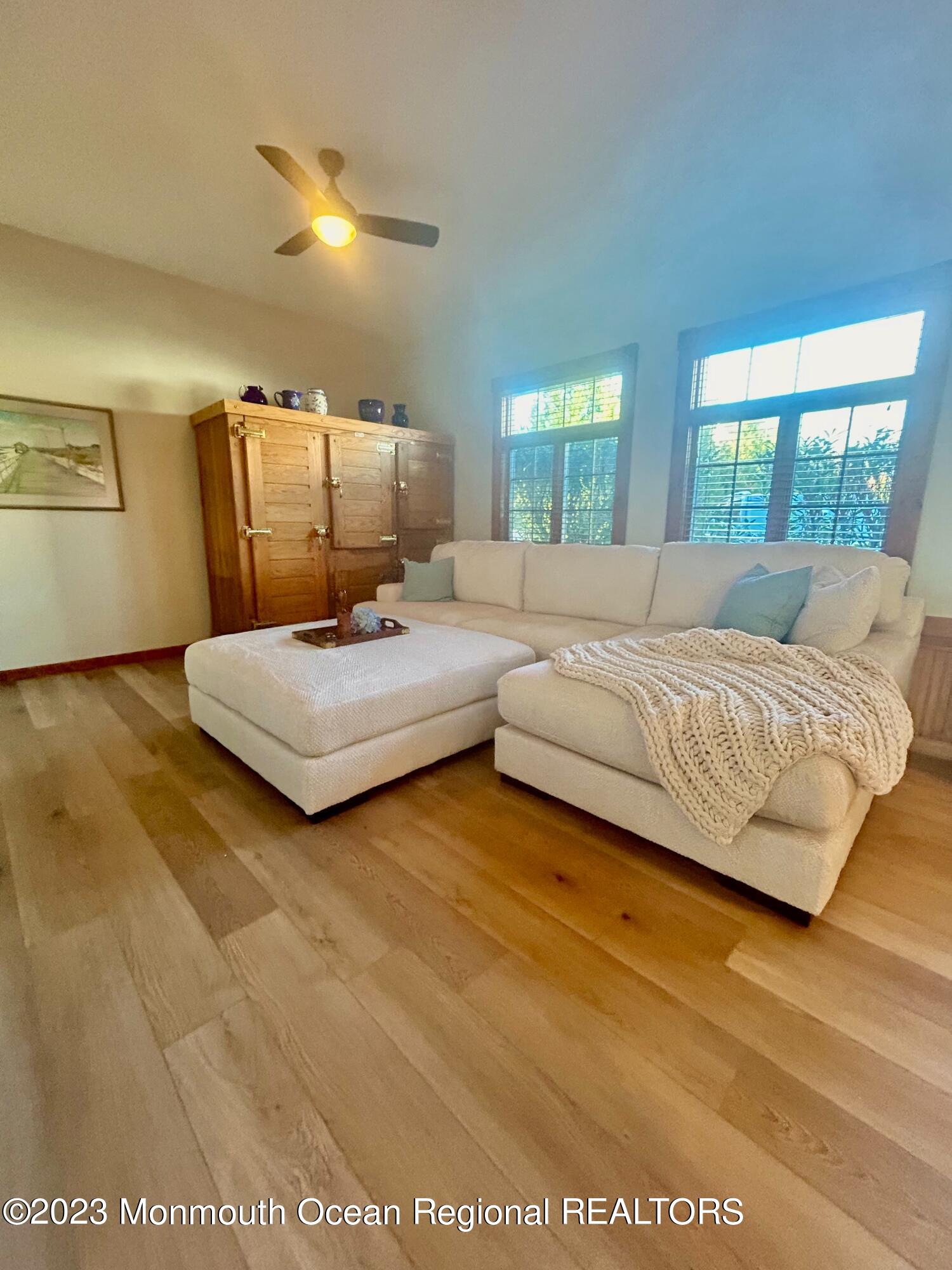 208 Passaic Avenue Spring Lake, NJ 07762 - Photo 9 of 19 a living room with a bed furniture and a large window