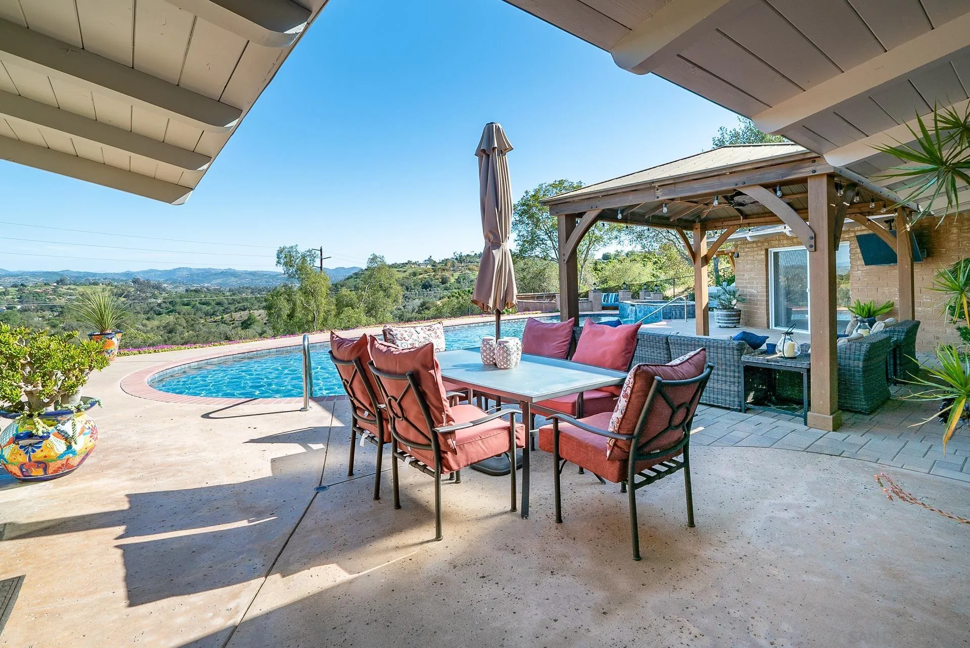 3978 Ladera Vista Road Fallbrook, CA 92028 - Photo 41 of 48 a view of a patio with a table chairs and a backyard