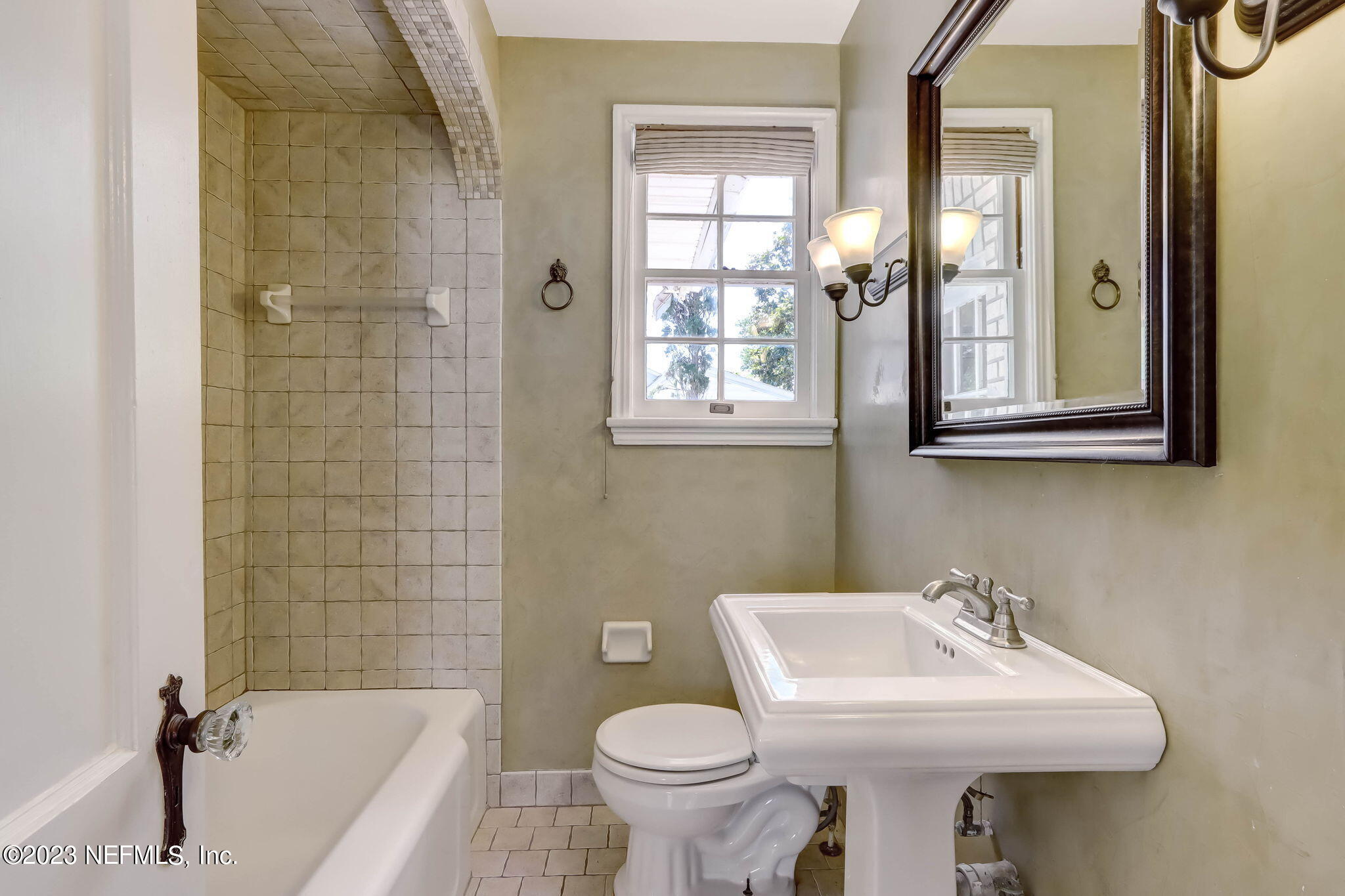 1642 Pershing Road Jacksonville, FL 32205 - Photo 12 of 29 a bathroom with a sink toilet and shower
