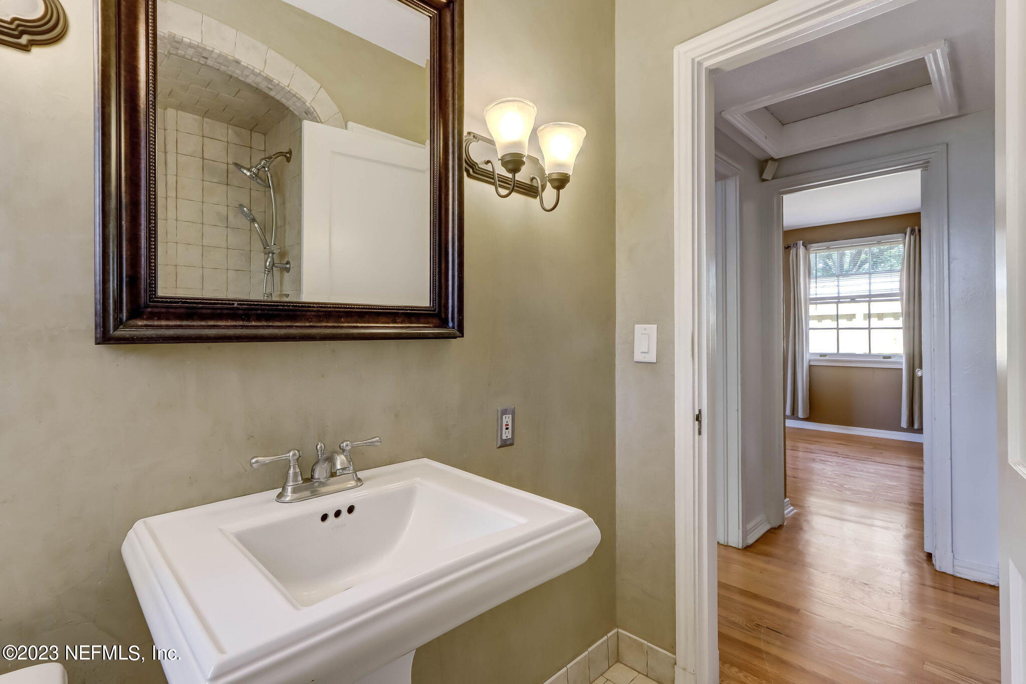 1642 Pershing Road Jacksonville, FL 32205 - Photo 14 of 29 a bathroom with a sink and mirror