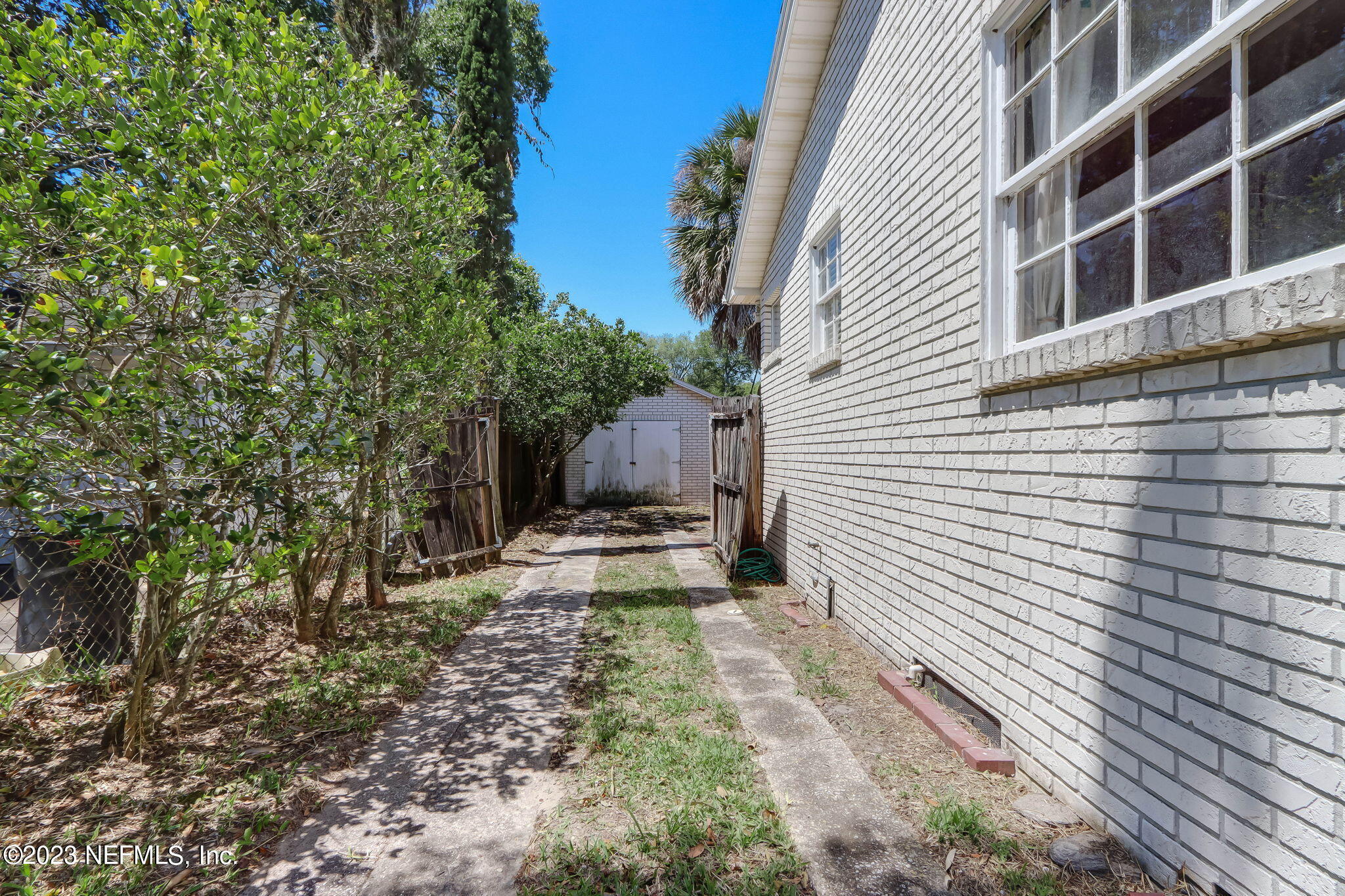 1642 Pershing Road Jacksonville, FL 32205 - Photo 15 of 29 a view of a house with backyard and wooden fence