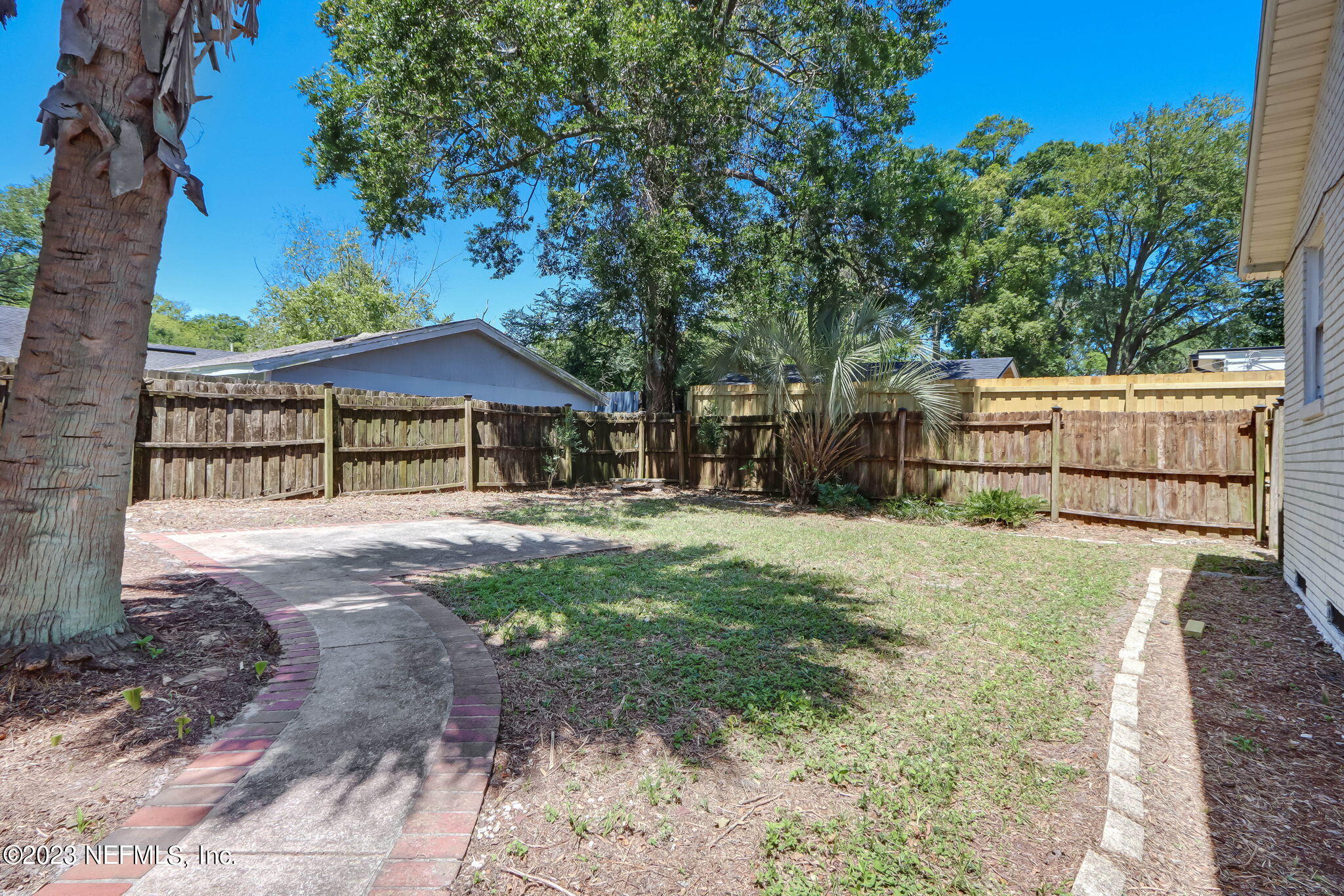 1642 Pershing Road Jacksonville, FL 32205 - Photo 17 of 29 a view of backyard with a garden and trees
