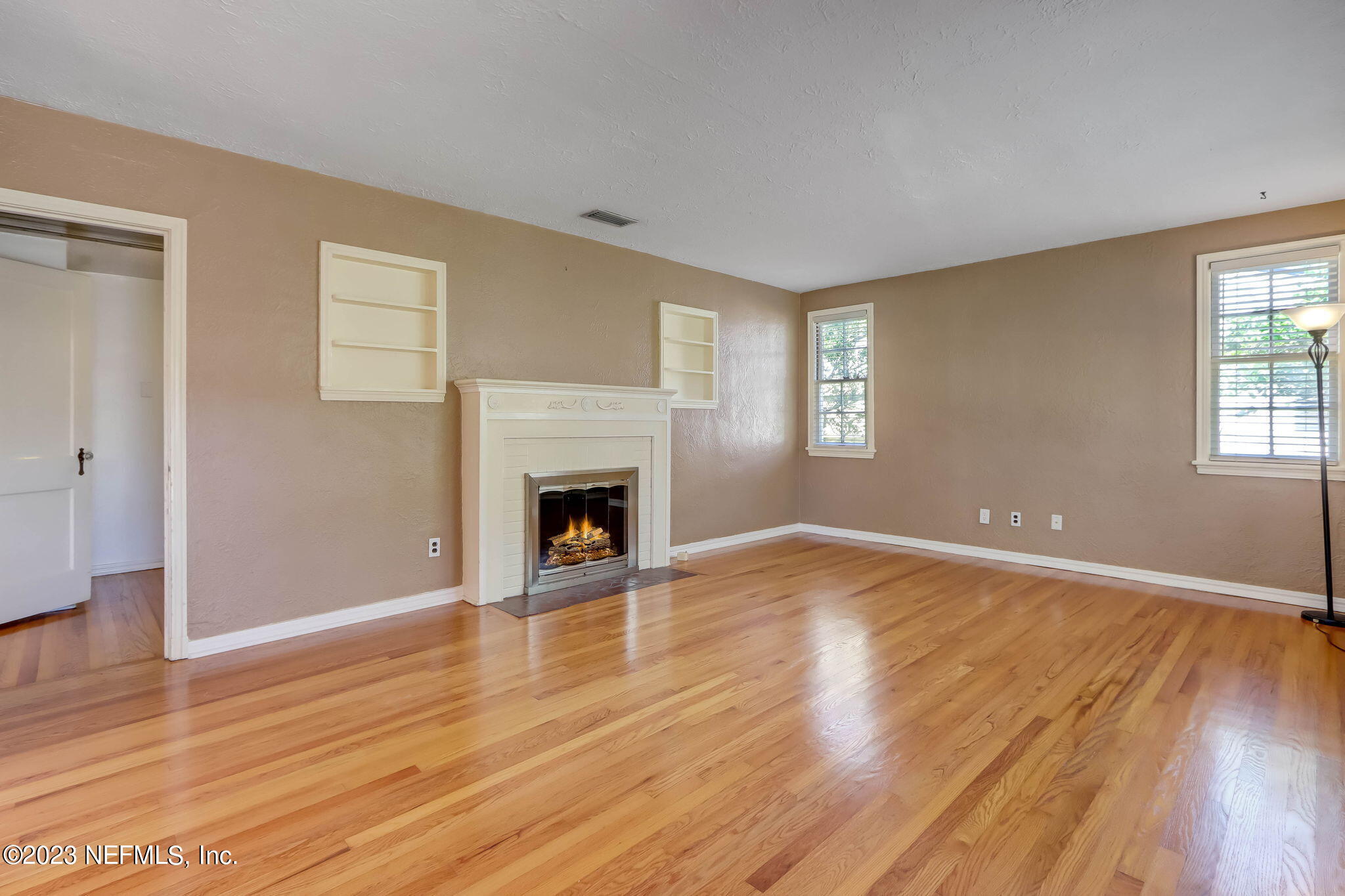 1642 Pershing Road Jacksonville, FL 32205 - Photo 3 of 29 a view of empty room with wooden floor and fireplace