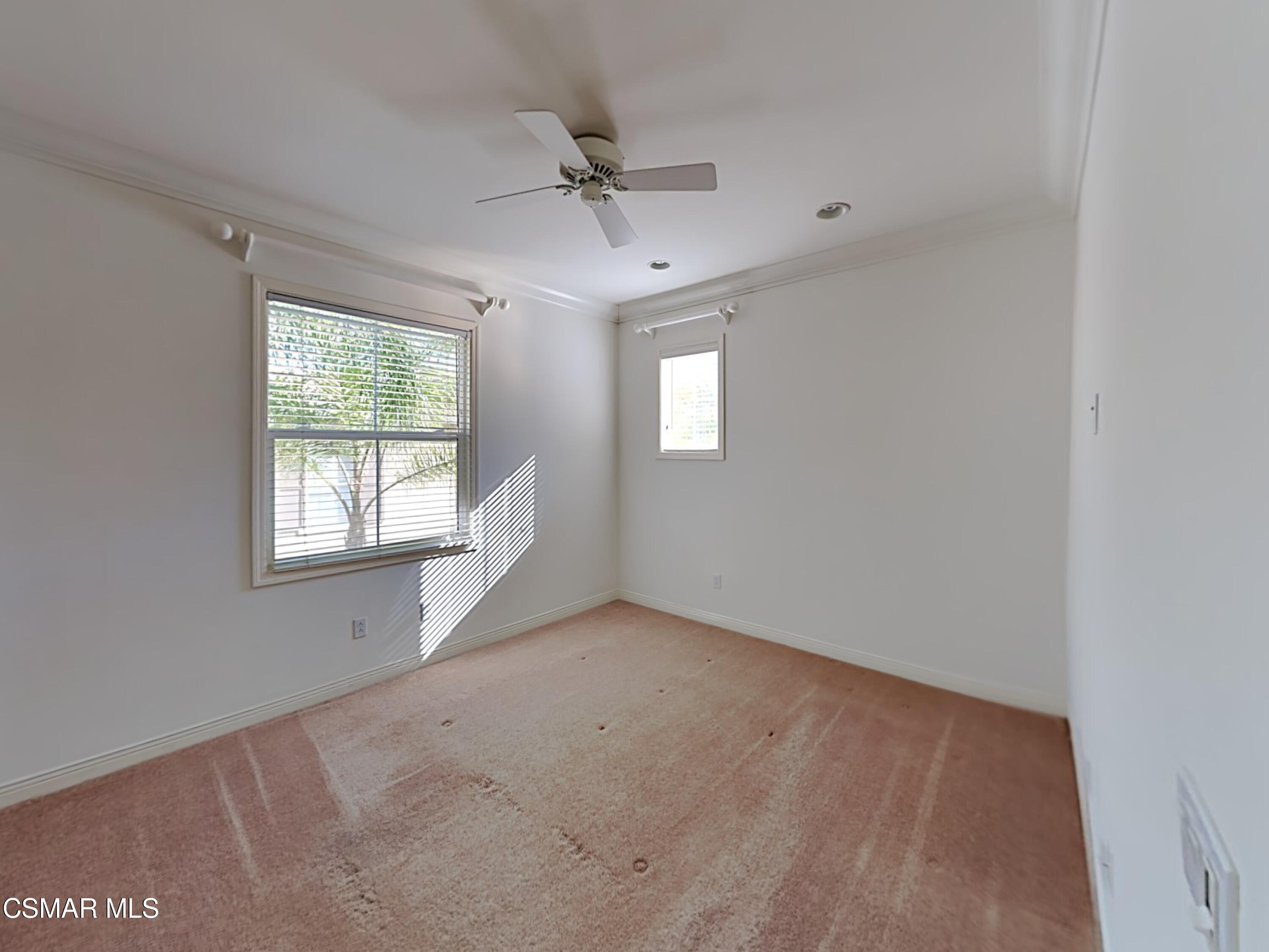 115 Parkside Drive Simi Valley, CA 93065 - Photo 11 of 27 an empty room with a window and a chandelier fan