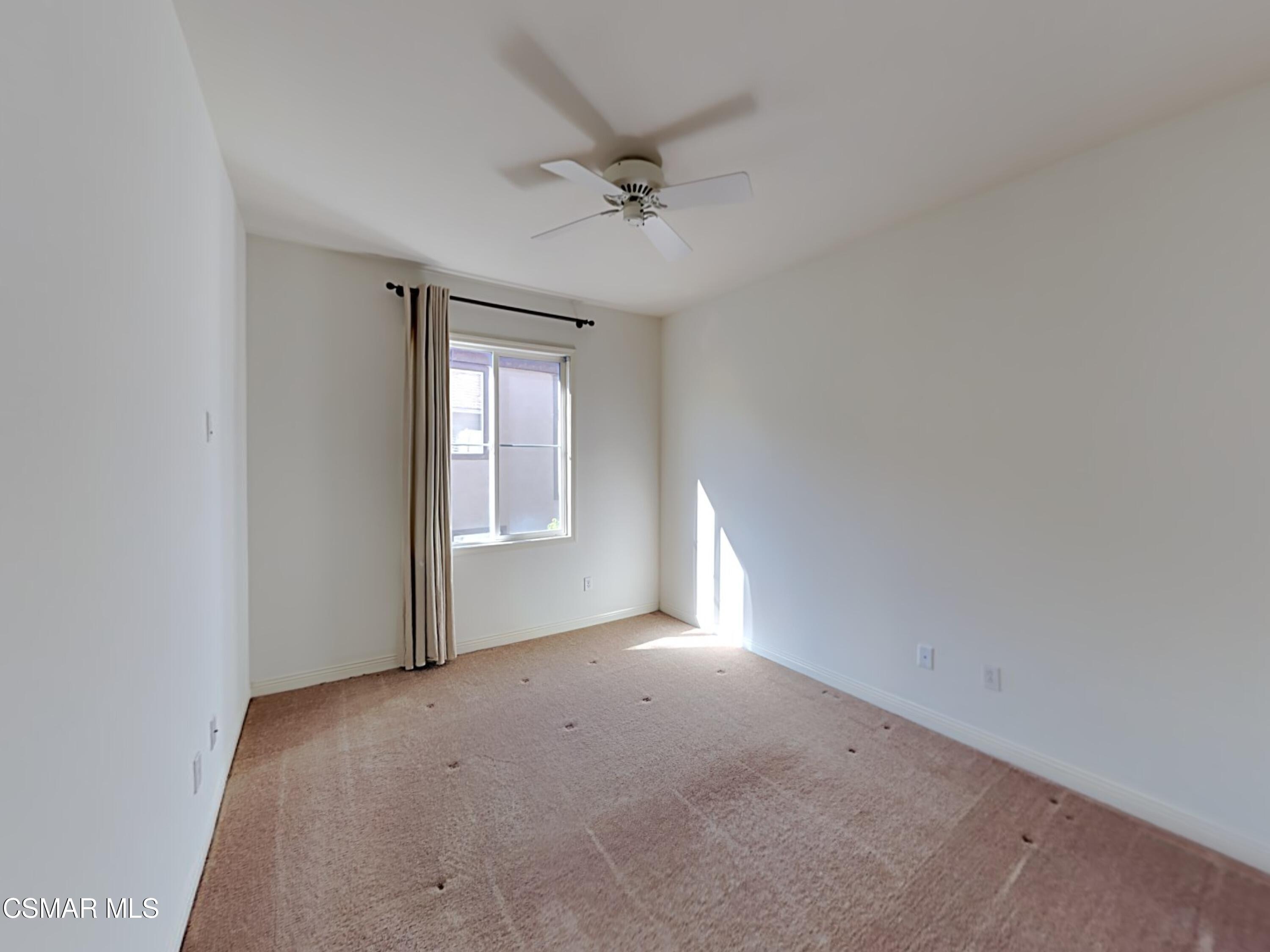 115 Parkside Drive Simi Valley, CA 93065 - Photo 13 of 27 an empty room with a ceiling fan and window