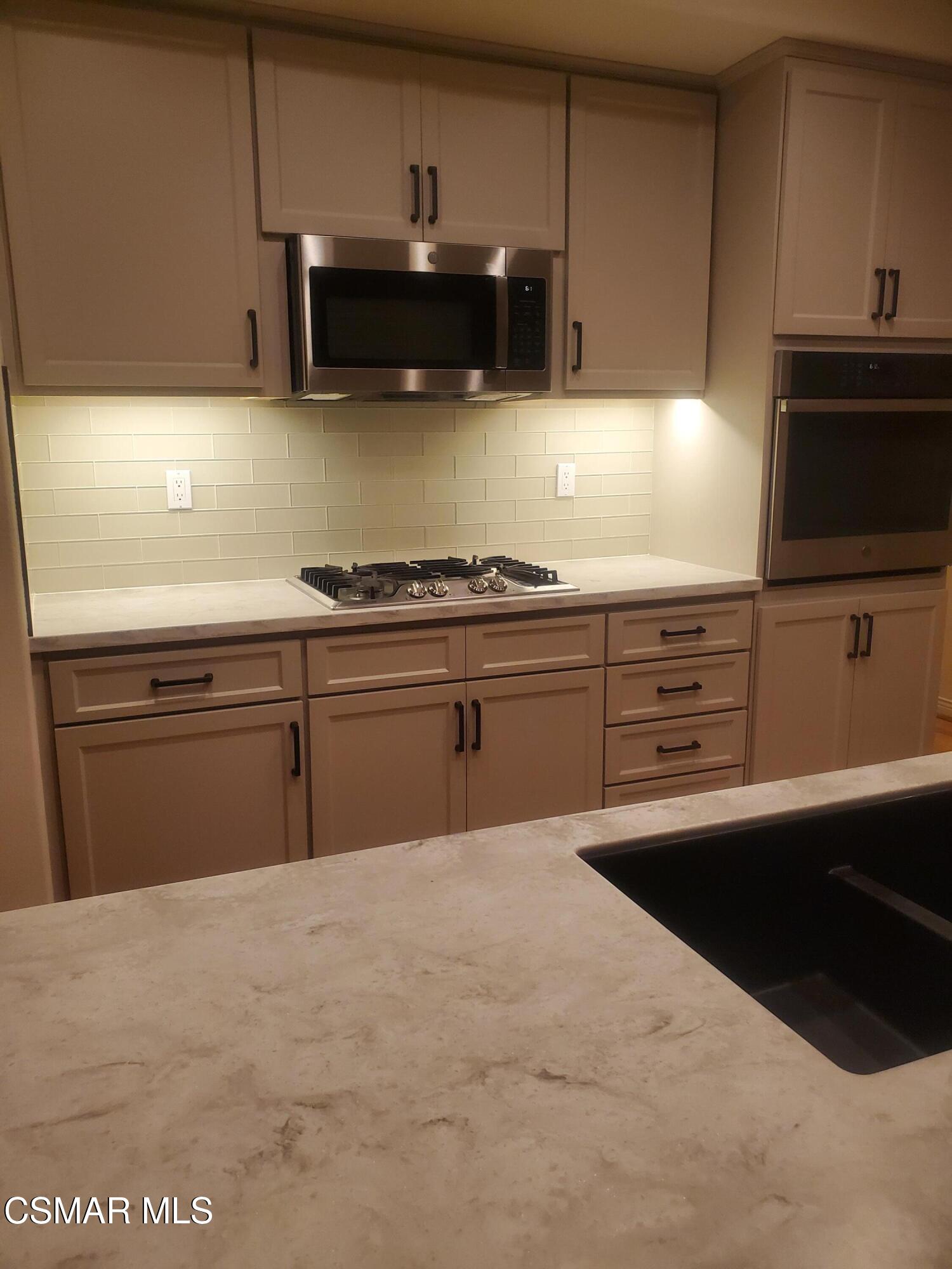 115 Parkside Drive Simi Valley, CA 93065 - Photo 4 of 27 a kitchen with granite countertop a sink and a stove