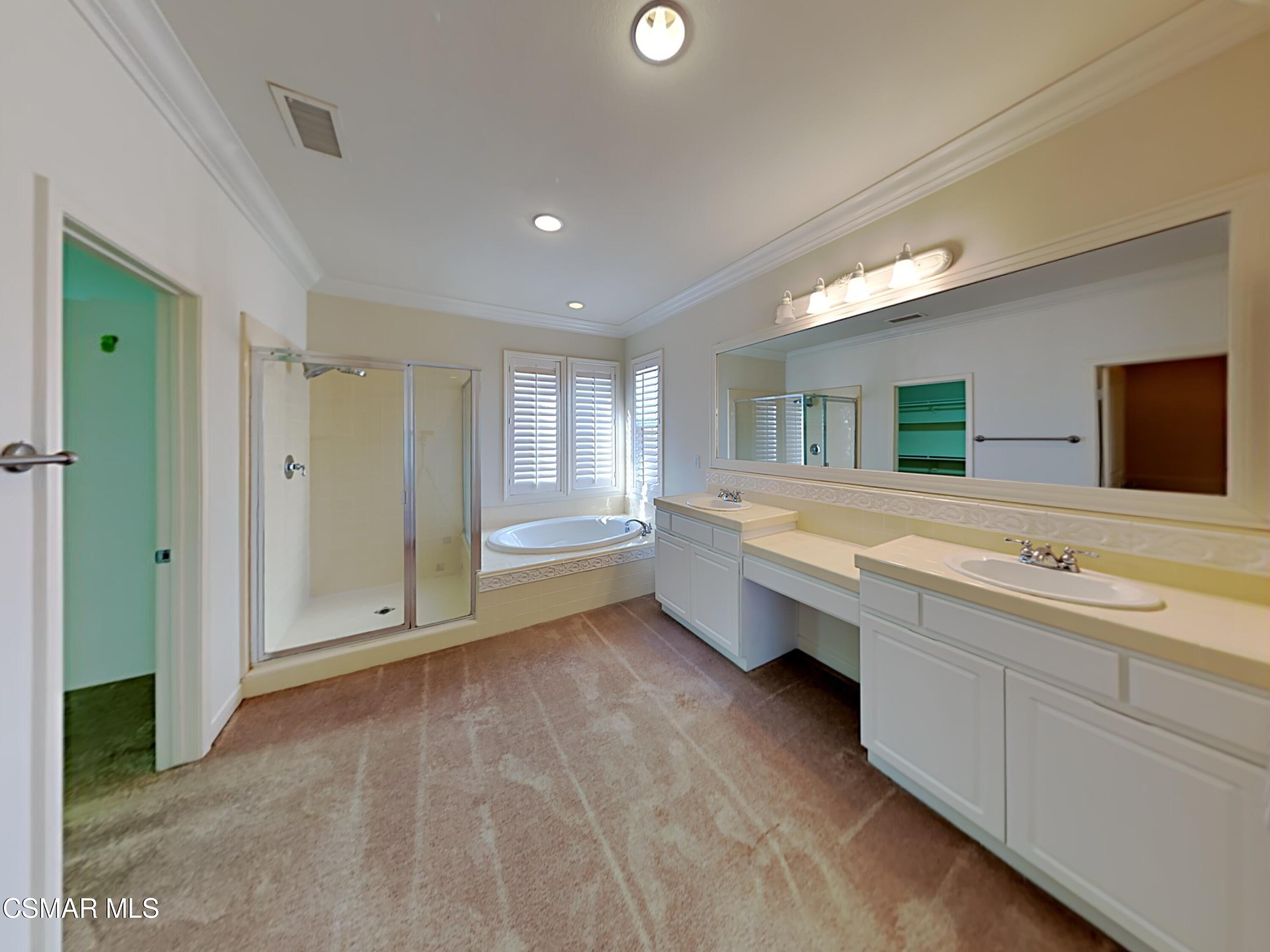 115 Parkside Drive Simi Valley, CA 93065 - Photo 10 of 27 a bathroom with a double vanity sink and mirror