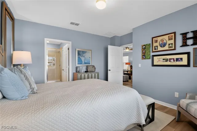 a bedroom with a bed and lamp