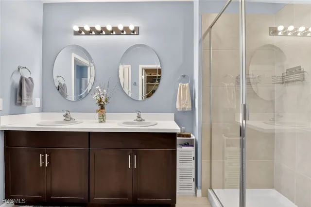 a bathroom with a double vanity sink and a mirror