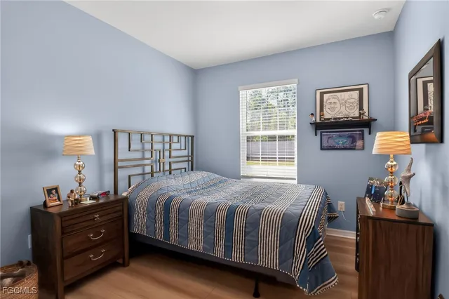a bedroom with a bed window and dresser