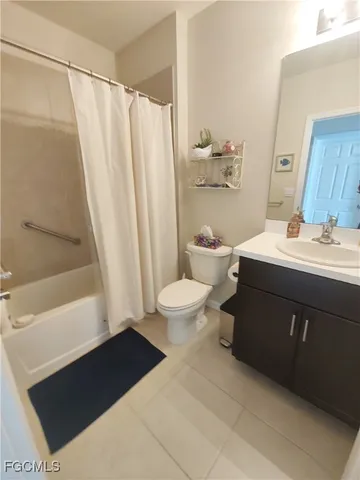 a bathroom with a sink a toilet a tub and shower