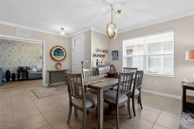 a view of a dining room and livingroom with furniture wooden floor and a clock