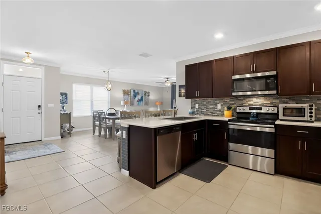 a kitchen with stainless steel appliances kitchen island granite countertop a refrigerator and a stove top oven
