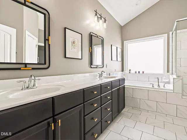 a bathroom with a double vanity sink mirror and double