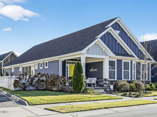 a view of a house with a yard and plants