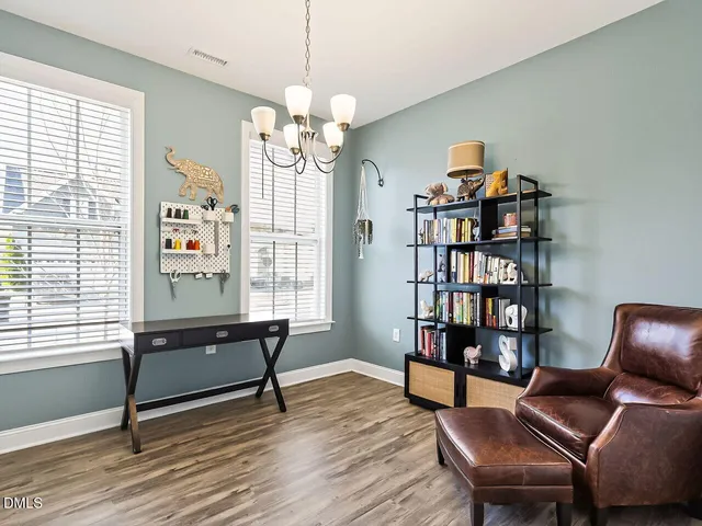 a view of a livingroom with furniture and a bookshelf