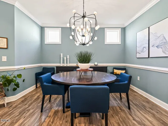 a dining room with furniture a window and wooden floor
