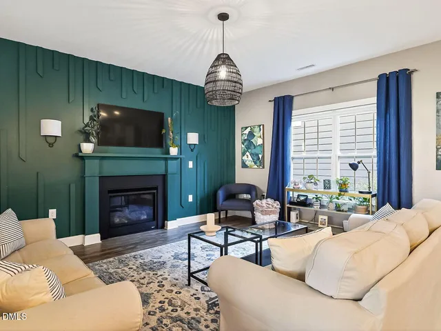 a living room with furniture a fireplace and a flat screen tv
