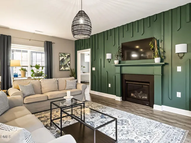 a living room with furniture a fireplace and a flat screen tv