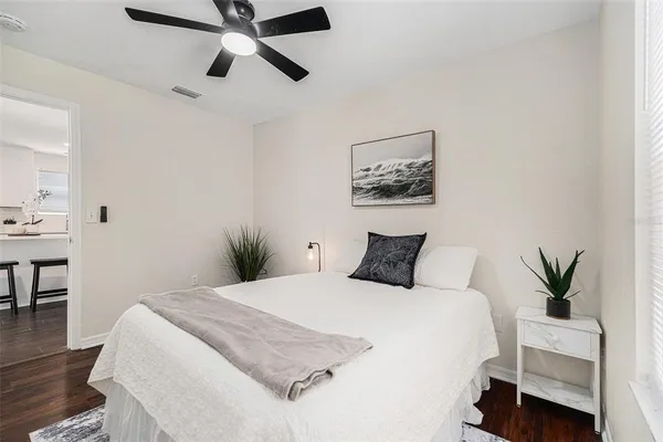 a bedroom with a large bed and a chandelier