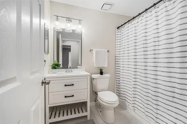a bathroom with a sink a toilet and mirror