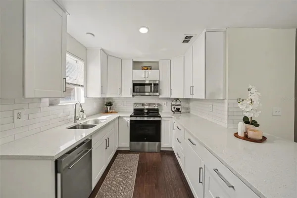 a kitchen with a sink stove and cabinets