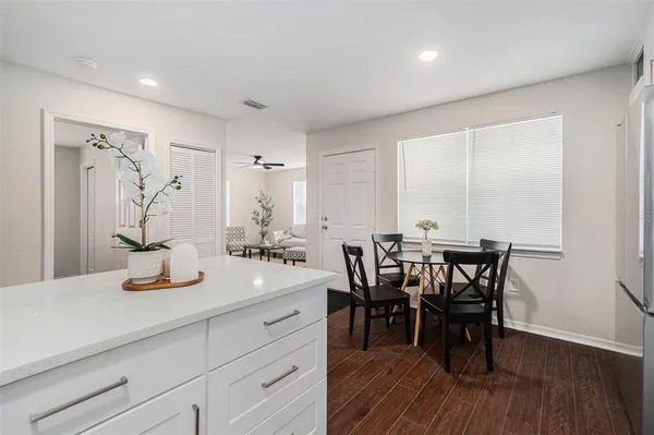 a view of a a dining room with furniture window and wooden floor